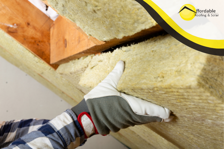 Homeowner installing insulation in the attic for improved energy efficiency.